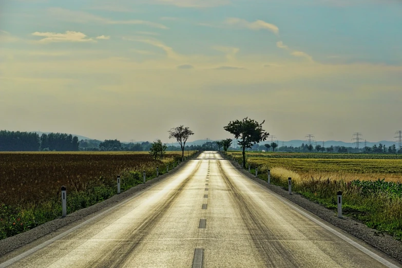 a long empty road in the middle of a field, a picture, flickr, view from the streets, hdr photo, combine, tourist photo