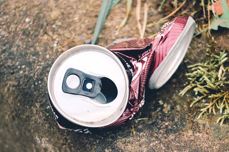 a can of soda sitting on the ground, a picture, pexels, broken parts, realistic detail, istock, disposable camera photo