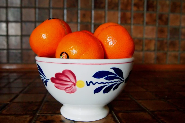 a close up of a bowl of oranges on a table, a still life, by David Garner, pexels, pop art, porcelain, happy!!!, unedited, 1 9 2 0's