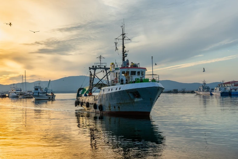 a large boat floating on top of a body of water, by Hristofor Žefarović, shutterstock, ships in the harbor, fishing, evening time, high quality product image”