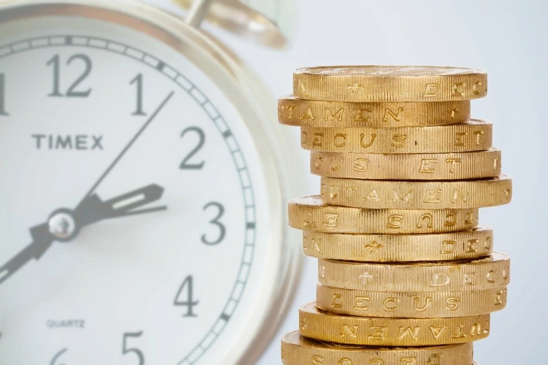 a stack of coins with a clock in the background, a stock photo, close up photo, high res photo