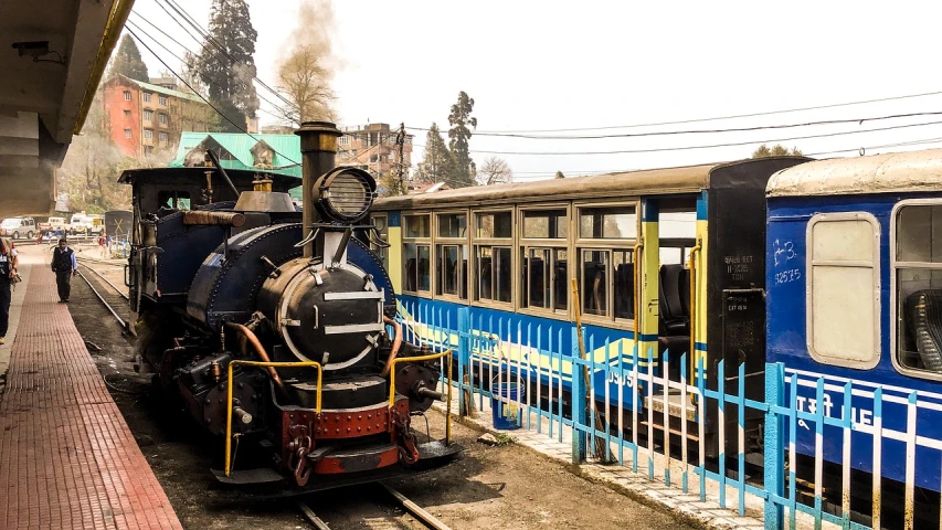 a train traveling down train tracks next to a train station, by Douglas Shuler, trending on pixabay, art nouveau, uttarakhand, a steam wheeler from 1880s, panorama shot, shot with sony alpha 1 camera