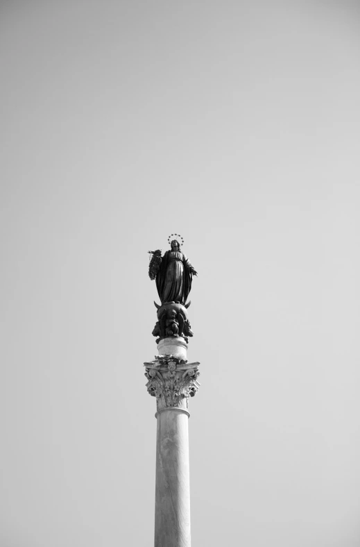 a black and white photo of a statue on top of a column, a statue, minimalism, venice, the city of lisbon, 8 0 mm photo