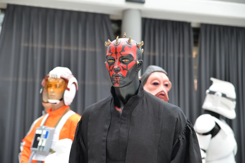 a group of star wars characters standing next to each other, a photo, by Edward Corbett, neo-dada, villain wearing a red oni mask, cosplay photo, close up shot from the side, london