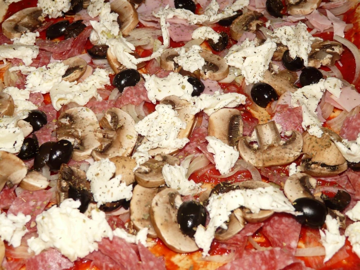 a pizza sitting on top of a pan covered in toppings, inspired by Coppo di Marcovaldo, supersharp photo