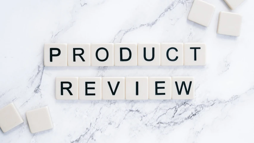 the words product review on a marble surface, 🔞🤡, drone photograph, 2019, 1 2 9 7