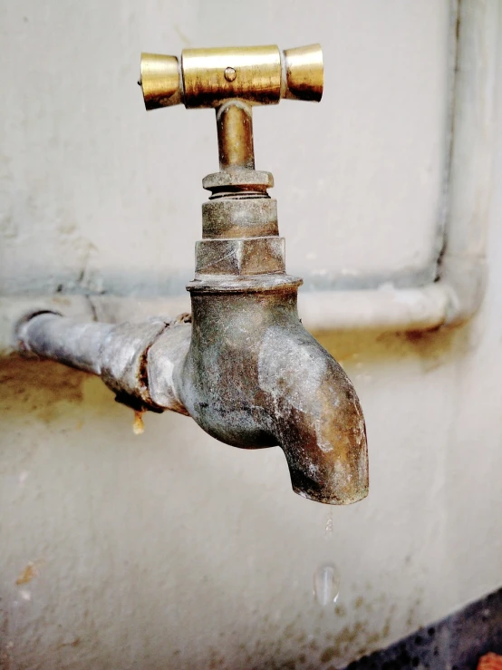 a close up of a water faucet on a wall, a photo, worn out, maintenance photo, tattered, very accurate photo