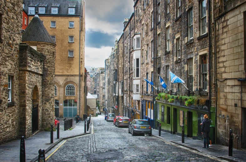 a cobblestone street lined with tall buildings, by John Murdoch, shutterstock, scottish, terraced, award winning”, vibrant but dreary