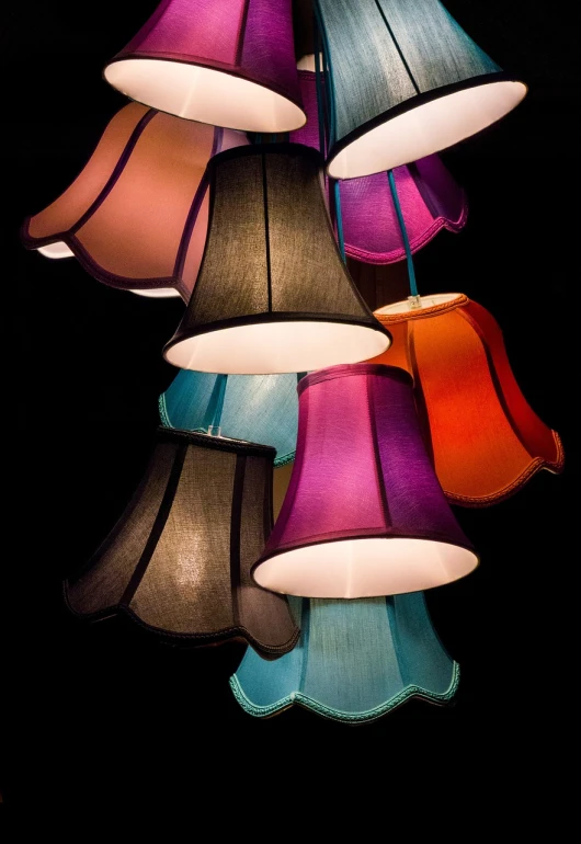 a bunch of lamps hanging from a ceiling, by Etienne Delessert, maximalism, bright on black, seams, vintage color, multiple colors