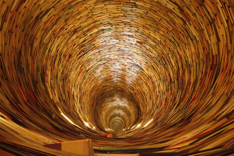 a book tunnel filled with lots of books, by Konrad Klapheck, flickr, concentric circles, an eerie whirlpool, read a directory book, annie leibowitz