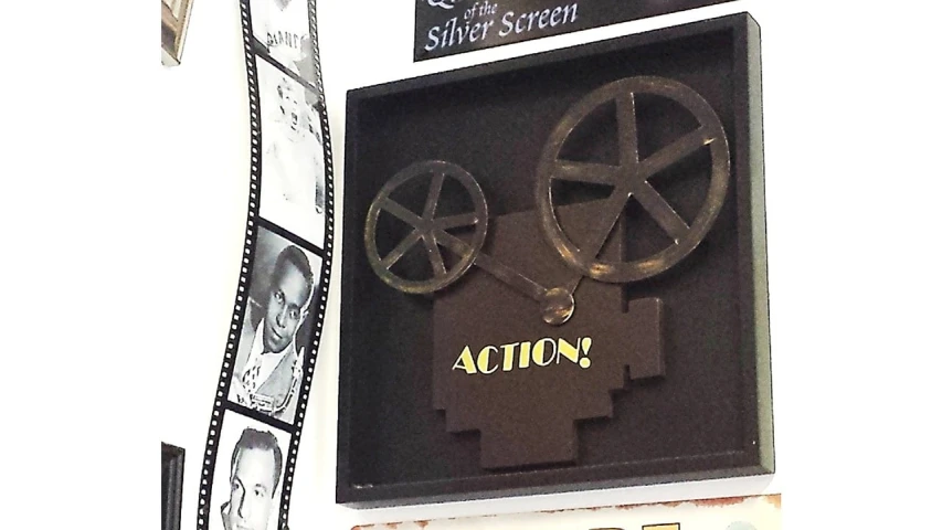 a clock mounted to the side of a building, a silk screen, inspired by Arlington Nelson Lindenmuth, cg society contest winner, kinetic art, movie action still frame, made out of shiny silver, sold at an auction, 3d flat layered paper shadow box