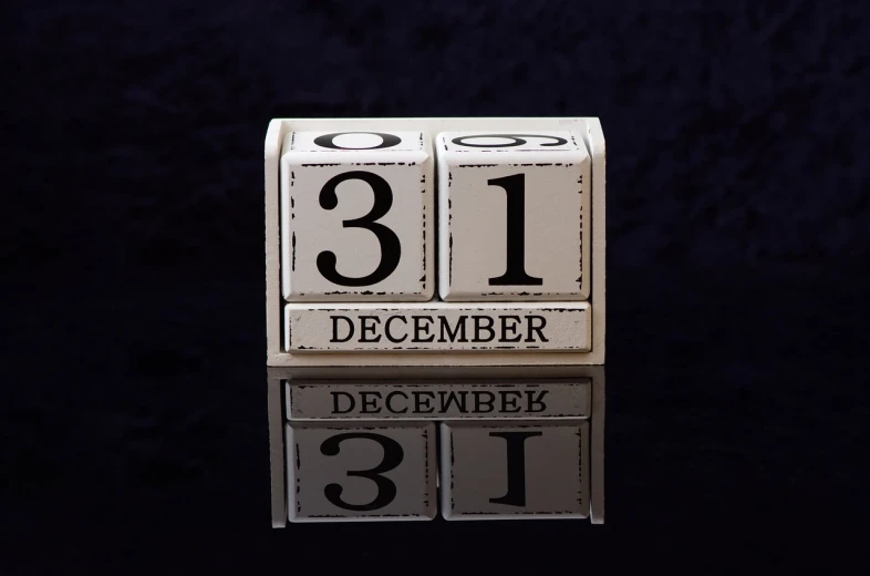 a wooden block with the number 31 on it, happening, (1 as december, with a black background, historical image, holiday