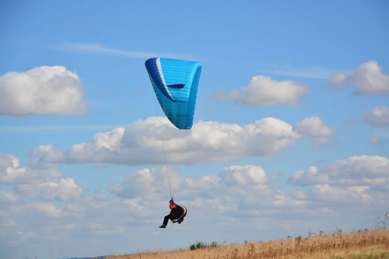 a person that is in the air with a kite, a picture, shutterstock, in the steppe, parachutes, spoiler, 4k photo”