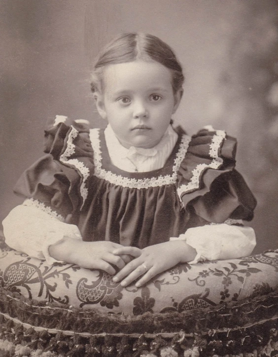 a black and white photo of a little girl, inspired by William John Thomson, flickr, victorian clothing, catalog photo, serious business, georgia anne muldrow