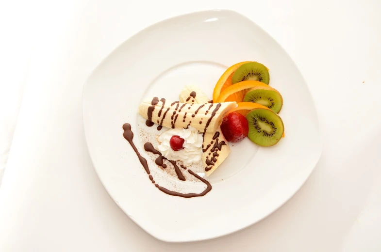 a white plate topped with fruit and ice cream, inspired by Jan Kupecký, flickr, chocolate sauce, high quality product photo, 555400831, fish made of pancake