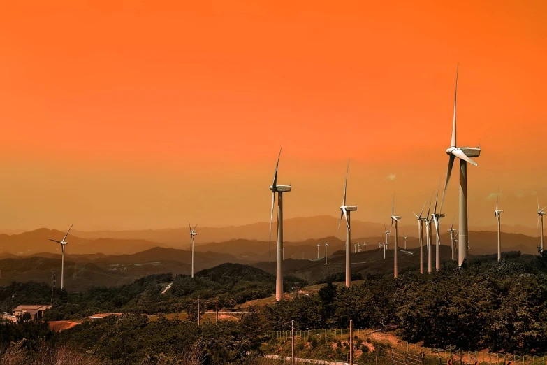 a group of wind turbines sitting on top of a lush green hillside, a colorized photo, by Tadashi Nakayama, romanticism, orange sunset, 4k detail, korean, maintenance photo