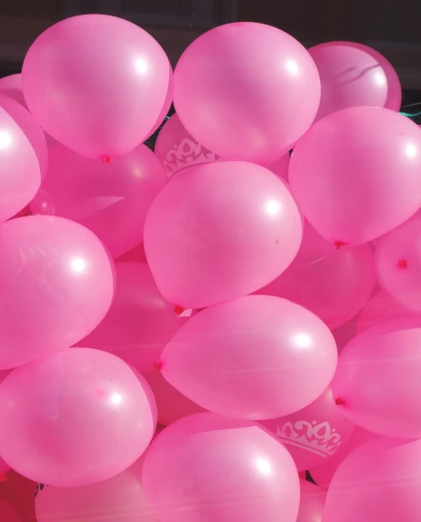 a bunch of pink balloons sitting on top of a table, a picture, pexels, crown of (pink lasers), closeup photo, istockphoto, view from bottom to top