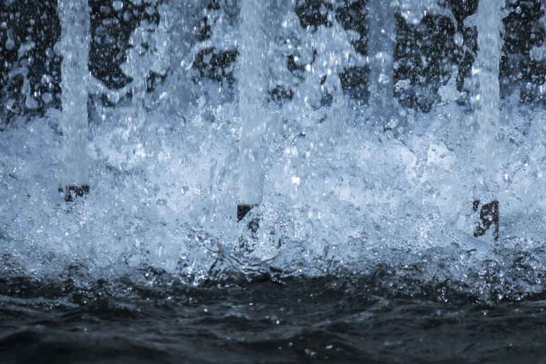 a black and white photo of a water fountain, a picture, shutterstock, water torrent background, blue water, black splashes, background image