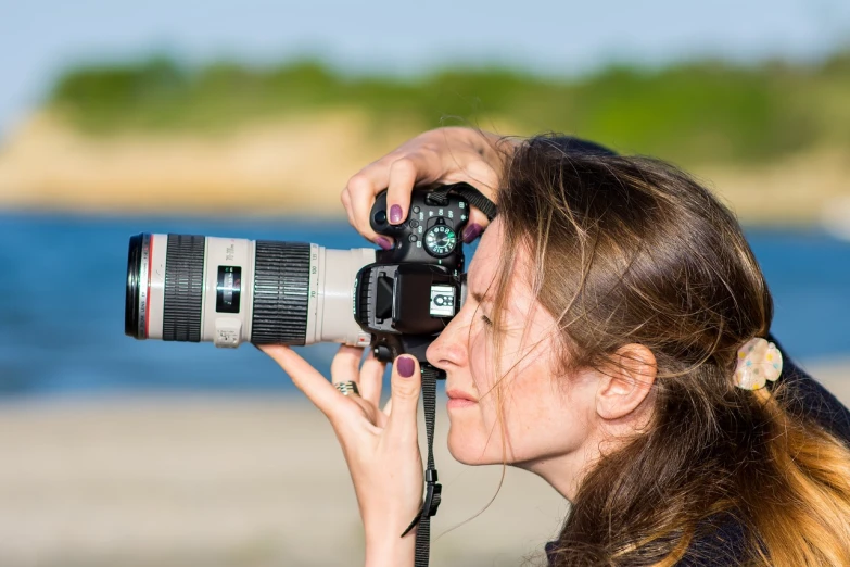 a woman taking a picture with a camera, a picture, by Mathias Kollros, shutterstock, art photography, telephoto vacation picture, canon- 70-200mm lens, environmental portrait, professional closeup photo