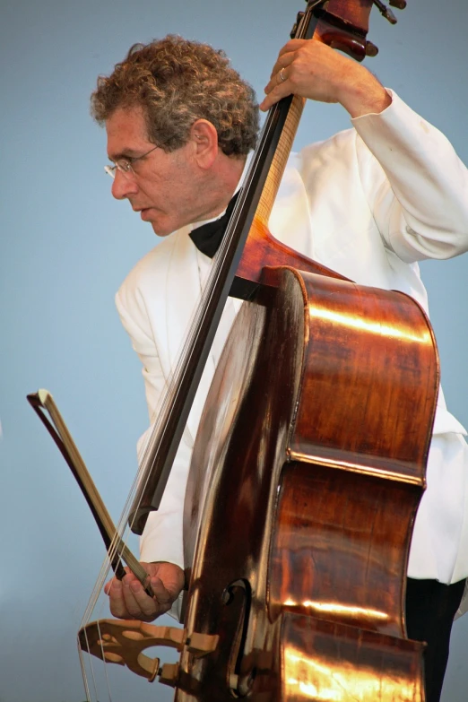 a man in a white shirt playing a cello, by David Garner, flickr, wearing a white tuxedo, belgium, bassist, elegant highly detailed