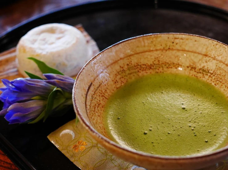a close up of a bowl of food on a tray, a picture, sōsaku hanga, loputyn and matcha, drink, creamy, vivid