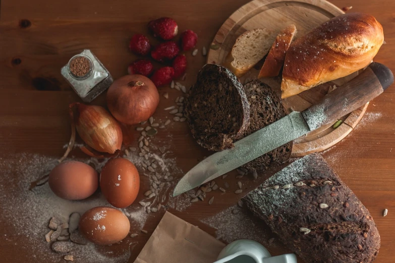 a bunch of bread sitting on top of a wooden table, a still life, by Aleksander Gierymski, pexels, avatar image, black forest, ingredients on the table, 3 4 5 3 1