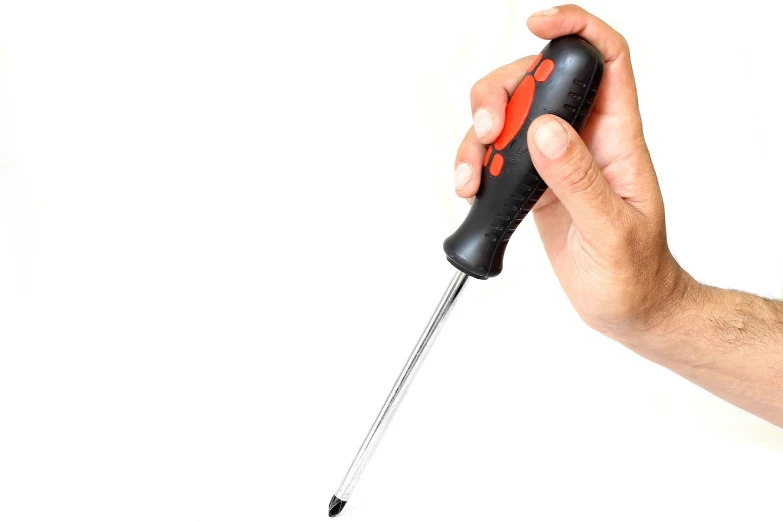 a close up of a person holding a screwdriver, by Juan O'Gorman, auto-destructive art, on a white background, professional product photo, it has a red and black paint, modern high sharpness photo