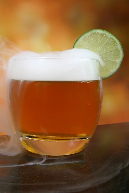 a glass of beer with a lime slice on top of it, by Tuvia Beeri, flickr, floating in smoke, inca themed smooth, lion's mane, low dof