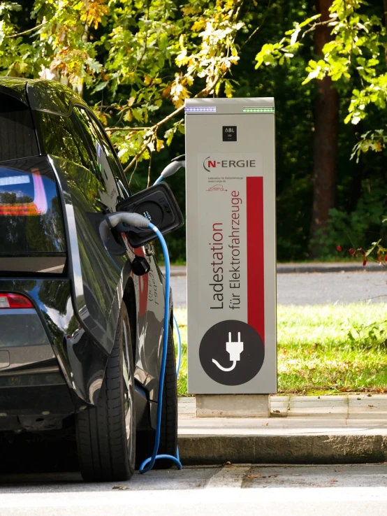 an electric car plugged into a charging station, by Etienne Delessert, shutterstock, les automatistes, advertising photo, wide screenshot, motivational, h.r. geiger