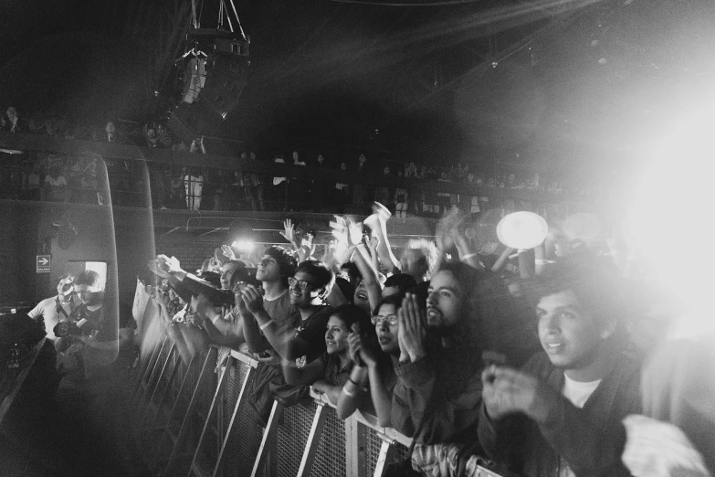 a black and white photo of a crowd of people, by Pablo Rey, concert photography, fujicolor with flash, 🎨🖌️, triumphant pose