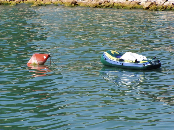 a couple of boats floating on top of a body of water, figuration libre, inflatable, very accurate photo, viridian and venetian red, partly sunken! in the lake!