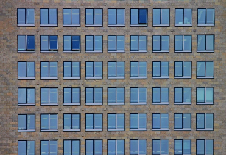 a tall brick building with lots of windows, by Andrei Kolkoutine, postminimalism, repetition, berlin, portait, zoomed in shots