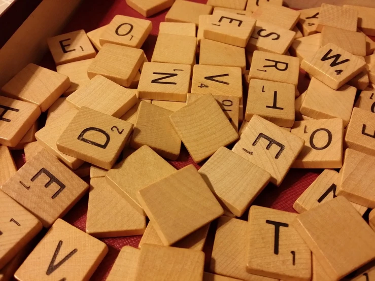 a box filled with wooden scrabbles sitting on top of a table, flickr, letterism, vd, upclose, twas brillig, pine