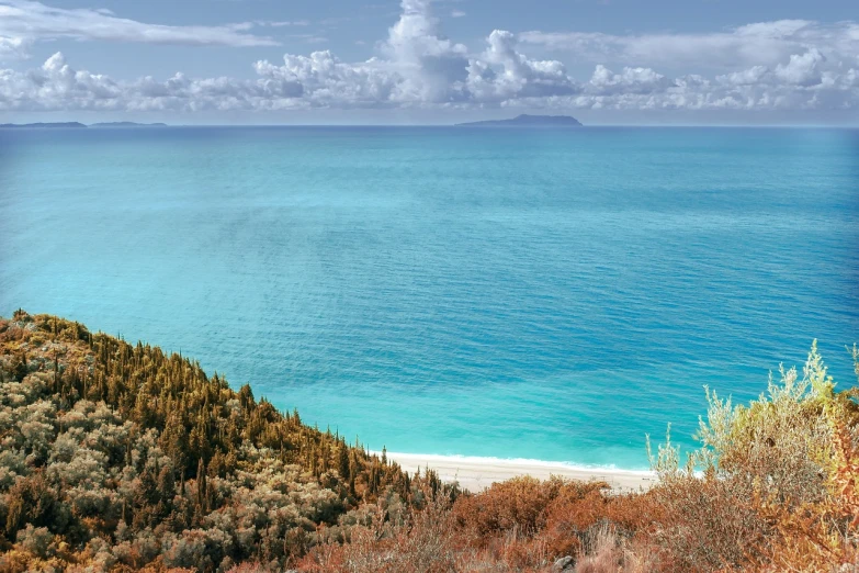 a view of the ocean from the top of a hill, a stock photo, by Julian Allen, shutterstock, fine art, michigan, turquoise water, fall, greek fantasy panorama