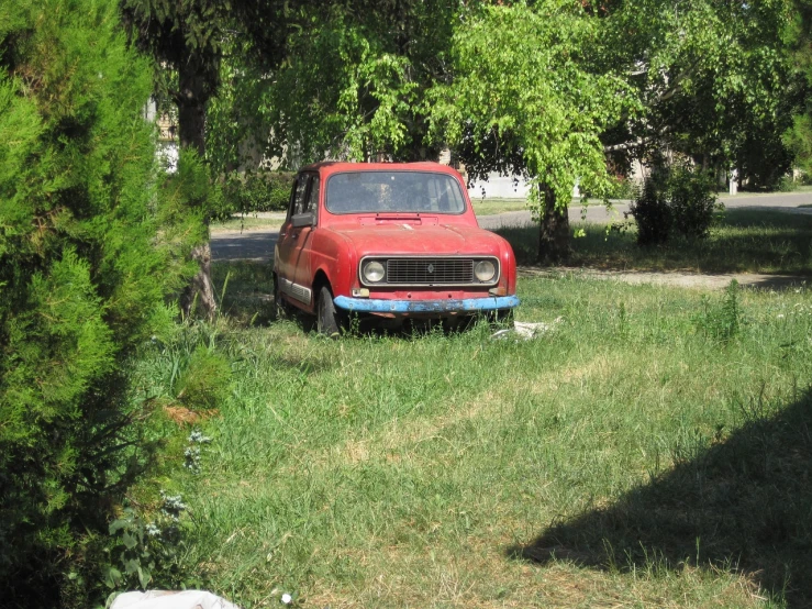 an old red truck is parked in the grass, by Muggur, renaissance, lada car, cleaned up, 2009, ebay photo