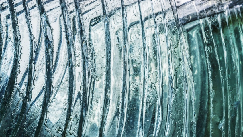 a close up of a wave of water, a macro photograph, inspired by Lucio Fontana, lyrical abstraction, pillars of ice background, transparent corrugated glass, vertical lines, hdr detail