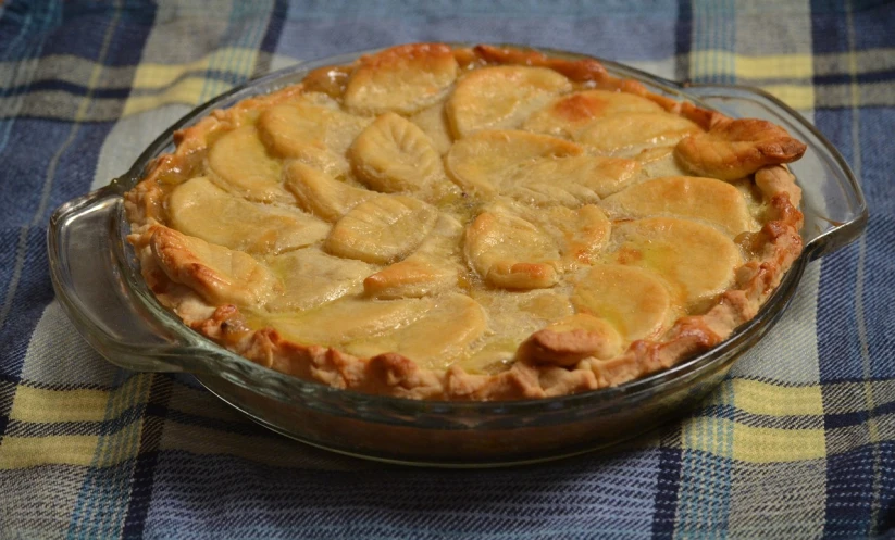 a close up of a pie on a table, inspired by Géza Dósa, banana, potato, canada, frontal shot