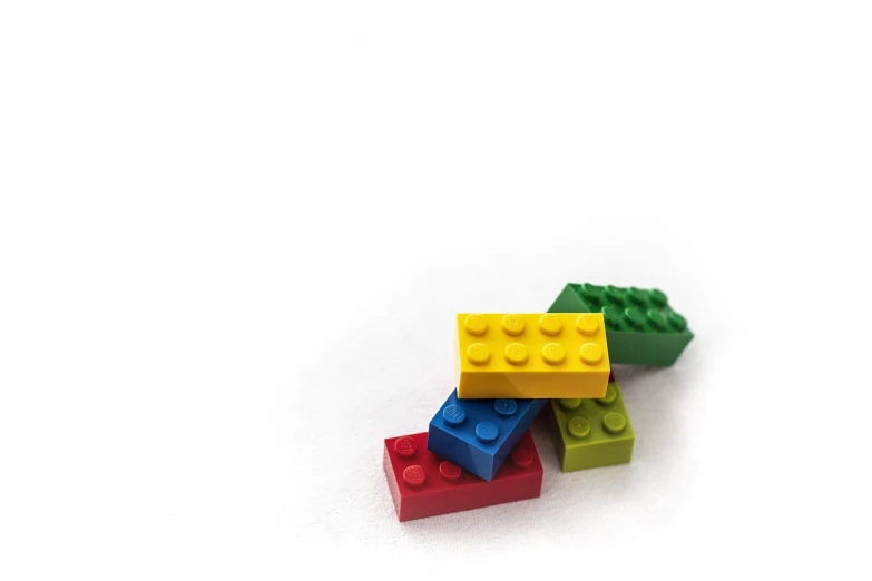 a pile of lego blocks sitting on top of each other, a stock photo, minimalism, on white paper, isolated background, colorful details, toy photo