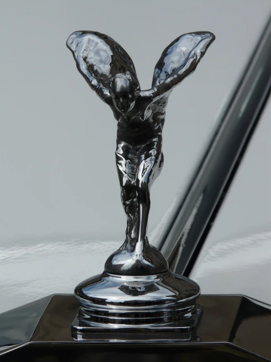 a close up of a hood ornament on a car, an art deco sculpture, by Paul Howard Manship, pixabay contest winner, transparent wings, full body shot close up, photorealism ”, wraith