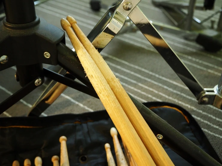 a bunch of drumsticks sitting on top of a bag, a picture, by Romain brook, flickr, fake hidden detail, drum scanner, bracts, wip