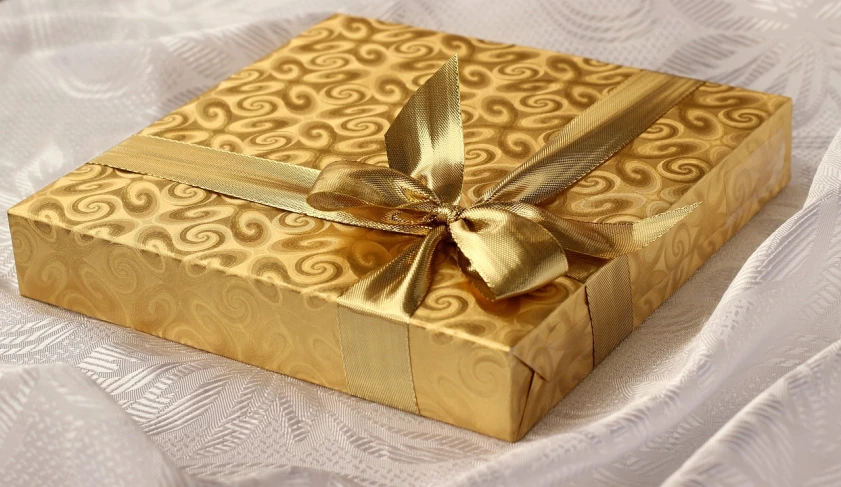 a gold gift box with a gold ribbon, a stock photo, by Maksimilijan Vanka, pixabay, gold linens, guilloche, photograph credit: ap, happy birthday