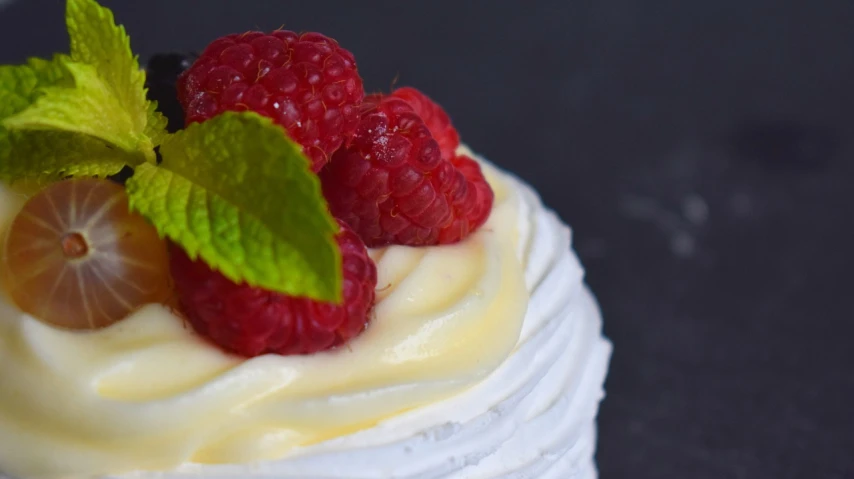 a dessert topped with whipped cream and raspberries, by Daniël Mijtens, unsplash, figuration libre, photorealistic detail, spiraling, 3/4 profile, detail