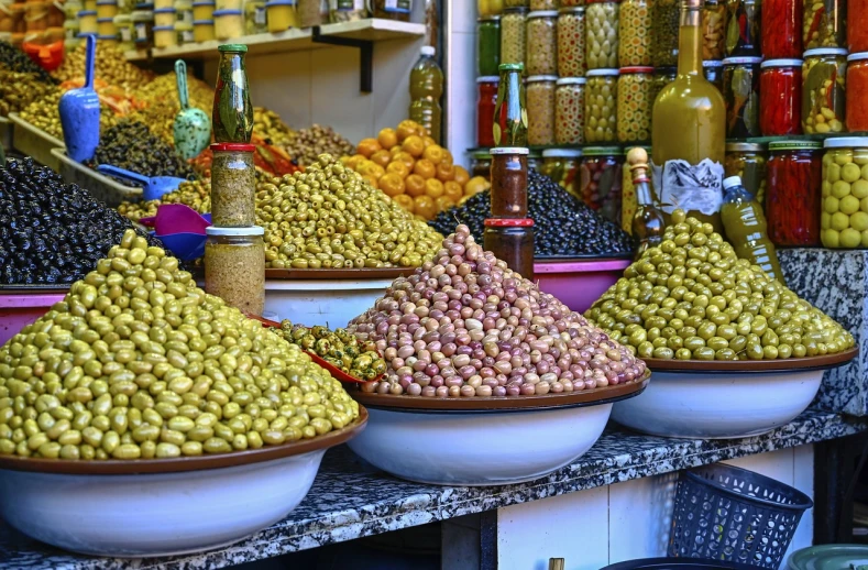 a market filled with lots of different types of olives, a photo, inspired by Alberto Morrocco, pexels, moroccan city, snapchat photo, stock photo, a tall