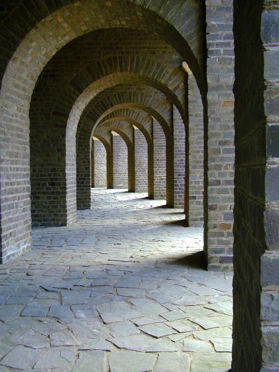 a row of arches in a brick building, by Wen Boren, flickr, elegant walkways between towers, great wall, shade, marsden