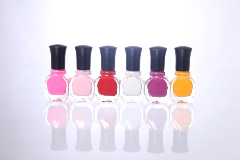 a row of nail polish bottles sitting next to each other, minimalism, product introduction photo