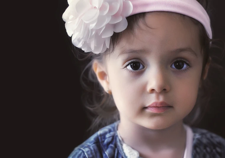 a little girl with a flower in her hair, by Lilia Alvarado, pixabay contest winner, photorealism, 2 years old, portrait. 8 k high definition, looking serious, photo of a beautiful