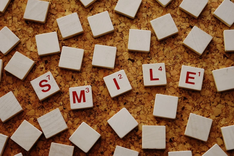 the word smile spelled in scrabbles on a cork board, by Milton Menasco, trending on pixabay, tiles, good smile company anime style, white, dialogue