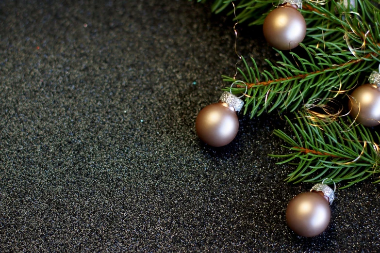 a close up of a bunch of ornaments on a tree, a photo, shutterstock, baroque, black sand, background image, fir trees, productphoto