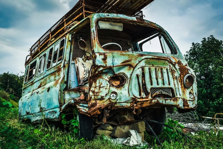 an old bus that is sitting in the grass, trending on pixabay, auto-destructive art, post apocalyptic background, dramatic closeup composition, highly contrasted colors, car crash