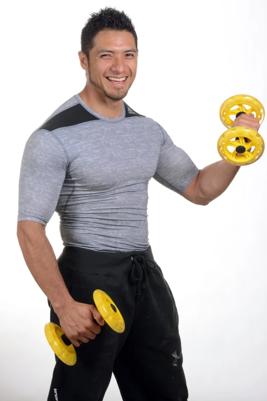 a man in a gray shirt holding two yellow dumbbells, by John Luke, dau-al-set, neoprene, sport bra and shirt, large eddies, amad